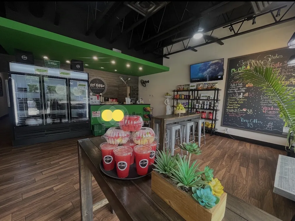 Inside an 80% Nutrition store with grab-and-go fridges, fresh juices and the smoothie menu board